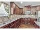 Kitchen features granite counters, stainless steel appliances and dark wood cabinets at 8051 Nolan Trl, Snellville, GA 30039