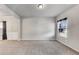 Neutral living room space featuring gray walls, plush carpet, and natural light at 8051 Nolan Trl, Snellville, GA 30039