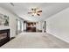 Bright living room with a fireplace that flows into the kitchen, creating an open and inviting space at 8051 Nolan Trl, Snellville, GA 30039