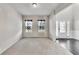 Neutral living room space featuring plush carpet, and natural light from two windows at 8051 Nolan Trl, Snellville, GA 30039