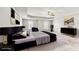 A staged main bedroom featuring a tray ceiling, a ceiling fan, and neutral colors at 8051 Nolan Trl, Snellville, GA 30039