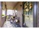 Close up of covered front porch with chairs, table, and door with floral wreath at 1444 Harbins Ridge Dr, Norcross, GA 30093