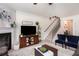 Living room with a fireplace, TV, and staircase at 504 Crescent Woode Dr, Dallas, GA 30157