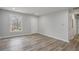 Bright living room with luxury vinyl plank flooring, fresh paint, and a large window providing natural light at 6565 Bussell Way, Riverdale, GA 30274
