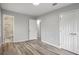 Main bedroom with wood-look floors and adjoining bathroom with tiled walk-in shower at 6565 Bussell Way, Riverdale, GA 30274