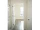 Hallway featuring an open doorway leading to a bright room with a window at 1752 Sw Pryor Sw Rd # 105, Atlanta, GA 30315