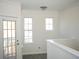 Open living space with light-colored walls, white trim, and access to a balcony at 1752 Sw Pryor Sw Rd # 105, Atlanta, GA 30315