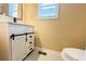 Small bathroom boasts a white vanity with black hardware and herringbone floor tile at 2650 Batavia St, East Point, GA 30344