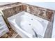 Soaking tub with tile surround in the bathroom at 2650 Batavia St, East Point, GA 30344