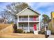 Two-story house with gray siding, white railings, and a red front door at 2650 Batavia St, East Point, GA 30344