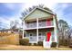 Two-story house with gray siding, white railings, and a red front door at 2650 Batavia St, East Point, GA 30344