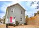 Two-story house with gray siding, red door, and small deck at 2650 Batavia St, East Point, GA 30344