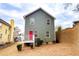 Two-story house with gray siding, red door, and small deck at 2650 Batavia St, East Point, GA 30344