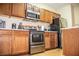 Well-equipped kitchen features stainless steel appliances and wood cabinets at 2650 Batavia St, East Point, GA 30344