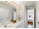 Bathroom features a double vanity with a large mirror and updated lighting at 313 Young James Cir, Stockbridge, GA 30281