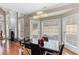 Bright dining room with modern chandelier, large windows, and decorative fireplace, with hardwood floors at 313 Young James Cir, Stockbridge, GA 30281