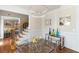 Chic dining room featuring a glass table, unique lighting, and elegant decor with staircase access at 313 Young James Cir, Stockbridge, GA 30281