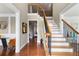 Elegant foyer featuring hardwood floors, a staircase with black iron spindles, and decorative molding at 313 Young James Cir, Stockbridge, GA 30281