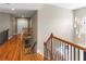 Spacious hallway with hardwood floors, wrought iron railing, and views to the lower levels at 313 Young James Cir, Stockbridge, GA 30281