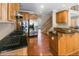 Spacious kitchen featuring stainless steel appliances, wooden cabinets, granite counters, and hardwood floors at 313 Young James Cir, Stockbridge, GA 30281