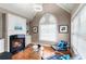 Cozy living room with fireplace, hardwood floors, modern decor, and lots of natural light at 313 Young James Cir, Stockbridge, GA 30281