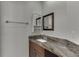 Bathroom vanity with granite countertop, dark cabinets, and decorative mirrors at 4011 Charrwood Trce, Marietta, GA 30062