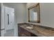 Bathroom featuring granite countertops with a vanity and a large, framed mirror at 4011 Charrwood Trce, Marietta, GA 30062