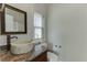 Bathroom featuring a natural stone vessel sink on granite countertops, with a framed mirror at 4011 Charrwood Trce, Marietta, GA 30062