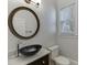 Bathroom featuring a modern black vessel sink on a vanity with a large, framed round mirror at 4011 Charrwood Trce, Marietta, GA 30062