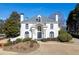 Stunning white home featuring manicured landscaping and architectural details at 4011 Charrwood Trce, Marietta, GA 30062