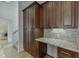 Kitchen with granite countertop, desk, and lots of wood cabinets at 4011 Charrwood Trce, Marietta, GA 30062