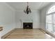 Elegant living room with a fireplace, chandelier, beautiful trim, and light wood floors at 4011 Charrwood Trce, Marietta, GA 30062