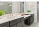 Bright bathroom featuring double sink vanity, marble-like flooring, quartz counters, framed mirrors and tiled shower at 405 Nettle Ct, Woodstock, GA 30188