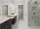 Modern bathroom with double vanity, marble-like tile, and a glass-enclosed shower offering a sleek design at 405 Nettle Ct, Woodstock, GA 30188