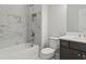 Bathroom with white marble-style tile and bronze fixtures, plus a bathtub and toilet at 405 Nettle Ct, Woodstock, GA 30188