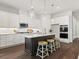 Elegant kitchen featuring white cabinets, stainless steel appliances, and a center island with bar stools at 405 Nettle Ct, Woodstock, GA 30188