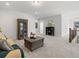 Spacious living room featuring neutral decor, a plush couch, decorative shelving, and hardwood staircase at 405 Nettle Ct, Woodstock, GA 30188