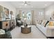 Cozy living room features neutral tones, comfortable seating, and bright natural light through a large window at 405 Nettle Ct, Woodstock, GA 30188