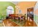 Dining room with hardwood floors and green and orange walls at 2270 Washington Dr, Douglasville, GA 30135