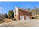 Three-car brick garage with a long driveway at 2270 Washington Dr, Douglasville, GA 30135