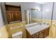 Clean bathroom with wood vanity and yellow tile at 2555 Klondike Sw Rd, Conyers, GA 30094