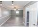 Bright bedroom features gray walls, ceiling fan, and new flooring at 2555 Klondike Sw Rd, Conyers, GA 30094