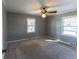 Spacious bedroom with neutral carpeting and gray walls at 2555 Klondike Sw Rd, Conyers, GA 30094