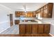 Galley kitchen with wood cabinets and white appliances at 2555 Klondike Sw Rd, Conyers, GA 30094