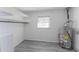 Laundry room includes shelving, water heater, and vinyl flooring at 2555 Klondike Rd Sw, Conyers, GA 30094