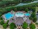 Aerial view of a community clubhouse with multiple pools, waterslide and wooded views at 320 Jessica Way, Canton, GA 30114