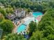 Aerial shot of the community clubhouse, pools, and waterslides surrounded by mature trees at 320 Jessica Way, Canton, GA 30114