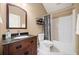 Bright bathroom showcasing a dark wood vanity, black countertop and shower and tub at 320 Jessica Way, Canton, GA 30114