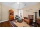 Cozy bedroom featuring a reading nook with patterned chairs and hardwood floors at 320 Jessica Way, Canton, GA 30114