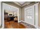 Inviting home foyer featuring a glass front door, hardwood floors, and a view into the office at 320 Jessica Way, Canton, GA 30114